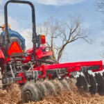 Mahindra 5100 Series Tractor with rotary cutting attachment.