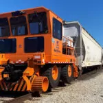 Rail King RK460 G7 mobile railcar mover moving many railcars.