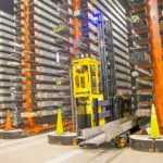 Combilift COMBI-AGT driving into narrow aisle with steel.