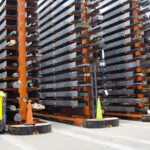 Combilift COMBI-AGT autonomous guided forklift trucks inside a warehouse with narrow aisles.
