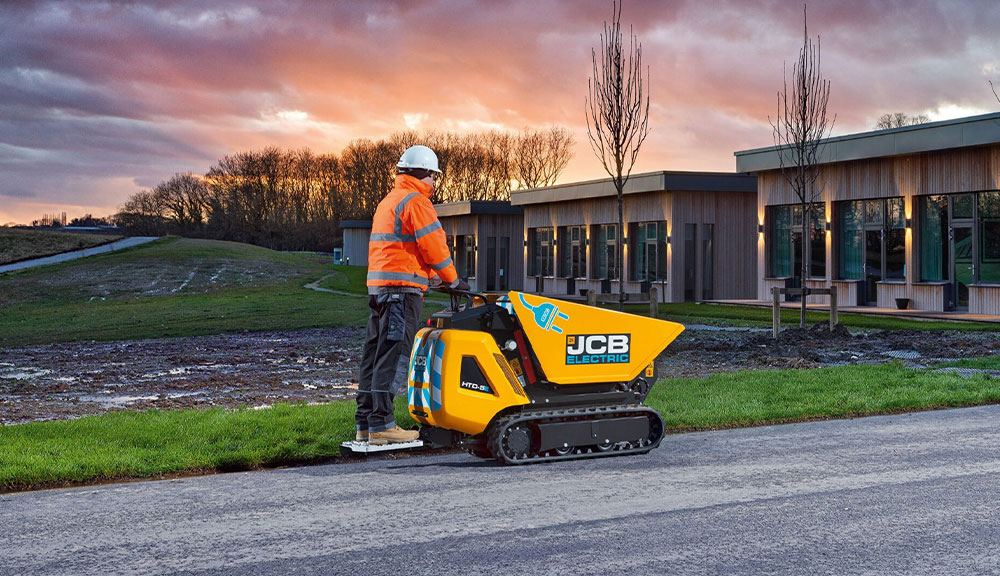 JCB HTD-5E electric dumper driving on road outdoors.
