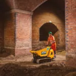 JCB HTD-5E electric dumper driving on dirt.