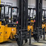 Bendi B3/30AC forklifts lined up in warehouse.