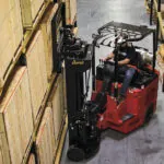 Bendi B40i5 LPG forklift lifting pallet off warehouse racking.