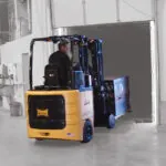 Bendi B40AC lift truck driving pallet of materials into semi trailer.