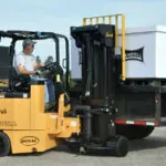Bendi B55AC lift truck placing pallet on truck trailer.