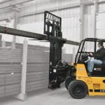 Drexel R60i5 LPG forklift placing long beam on cantilever racking.