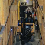 Drexel SL60AC forklift in very narrow warehouse aisle.