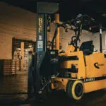Drexel SLT30AC electric forklift in manufacturing warehouse.