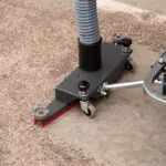 Nilfisk VHB436 Industrial Vacuum sucking up and clearing floor debris.