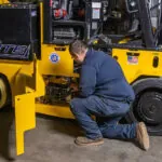 Technician servicing RICO AC Electric Pegasus forklift.