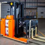 RICO EX straddle truck with raised forks.