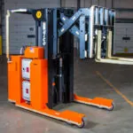 RICO EX straddle truck, mast and forks raised.