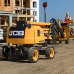 JCB AJ48D boom lift driving at jobsite.