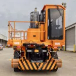 Worker driving Rail King G7 Railcar mover.