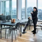 worker scrubbing cafe floors with Dryft micro scrubber.