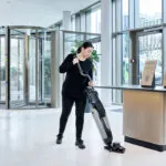 Worker cleaning entryway floors with Advance Dryft micro scrubber.