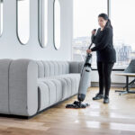 Worker cleaning office floors with Dryft micro scrubber.