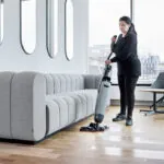Worker cleaning office floors with Dryft micro scrubber.