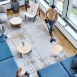 Advance VU200 upright vacuum cleaning rug in lobby sitting area.