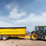 JCB 8330 Fastrac agricultural tractor hauling large implement.
