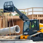 JCB 4TS-8T Teleskid on construction site raising concrete materials.