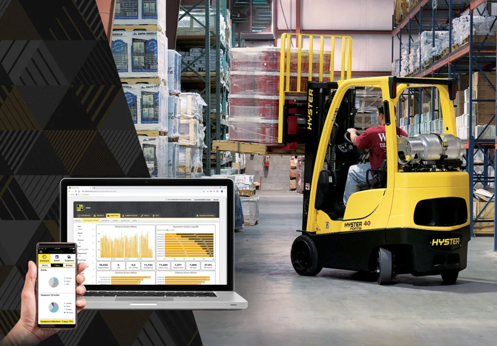Hyster forklift in warehouse, with telematics tracking data visible on nearby computer and phone.