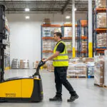 Operator using TASK Boa X-Ai autonomous legless stacker in warehouse.